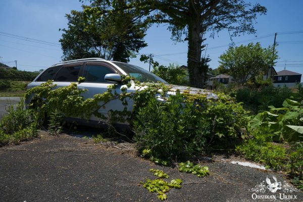 Fukushima Pachinko Japan Haikyo Forgotten and Overgrown Car in Parking Lot